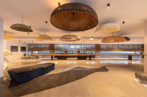 a large lobby with a large couch and umbrellas at Travelodge Nimman in Chiang Mai +91 photos