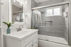 a white bathroom with a sink and a shower at Central Apartment in a Hip Walkable Neighborhood NRP23-01143 in Long Beach