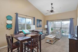 a living room with a dining room table and a couch at Cozy Top Floor 2BR Condo with View and Amenities!! in Branson