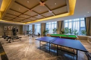 a pool room with two ping pong tables in it at S&N Xuanting Hotel Pengze in Pengze