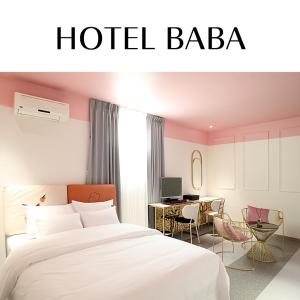 a hotel bedroom with a bed and a desk at Baba Hotel Gimcheon in Gimcheon