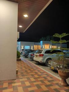 eine Gruppe von Autos, die auf einem Parkplatz geparkt sind in der Unterkunft Sagrado Hotel in Aguachica