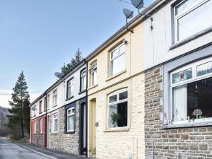 a row of brick buildings on a street at Afan Adventure in Cymmer