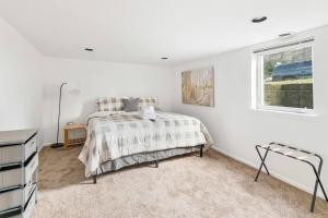 a white bedroom with a bed and a window at Beautiful home, Central location, Close to Beach in Seattle