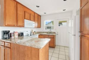 a kitchen with wooden cabinets and a counter top at Beautiful home, Central location, Close to Beach in Seattle