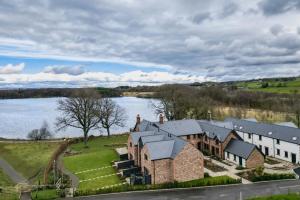 an aerial view of a building next to a body of water at Tarn End Cottage 8, Talkin Tarn, Brampton in Carlisle +17 photos