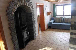 a living room with a brick fireplace and a couch at Knappenhaus in Rauris