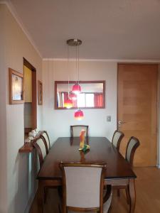 a dining room with a wooden table and chairs at Departamento en Alameda Talca in Talca