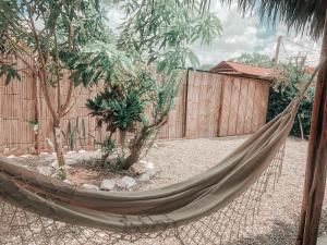 a hammock in a backyard with a fence at Ayampe Lofts in Ayampe