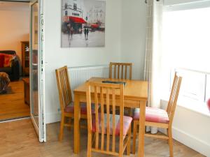 a dining room table and chairs in a room at Townend Cottage in Aikton