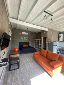 a living room with a couch and a bed at La Cambicha in Uribelarrea