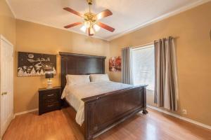 a bedroom with a large bed and a ceiling fan at A Spanish Castle For Your Living Pleasure in Little Rock