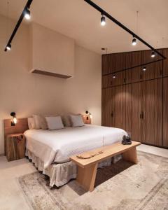 a bedroom with a large bed and a wooden cabinet at Casa Nova Centro Oaxaca - Adults Only in Oaxaca City +37 photos