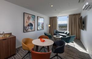 a hotel room with a table and chairs at TRYP by Wyndham Pulteney Street Adelaide in Adelaide