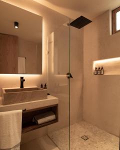 a bathroom with a sink and a glass shower at Casa Nova Centro Oaxaca - Adults Only in Oaxaca City