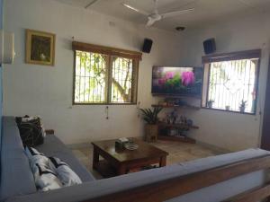 a living room with a couch and a coffee table at Transient House in Puerto Galera