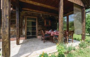 a dining table on a porch of a log cabin at 3 Bedroom Beautiful Home In Lekenik in Gračanica