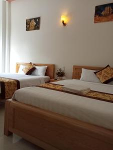 Postel nebo postele na pokoji v ubytování Khách sạn Trọng Tín