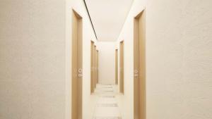an empty corridor with white walls and a ceiling at Grand TheoNi Boutique Hotel & Spa in Vasiliki