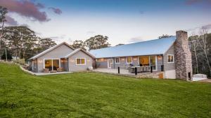 a house with a large lawn in front of it at Amaroo in Bowral