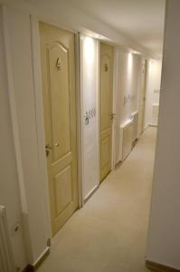 a hallway with white doors and a tile floor at Retro Hostel in Cluj-Napoca