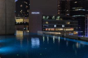 a pool in the middle of a city at night at Bukit Bintang Signatures by Premium Hospitality in Kuala Lumpur