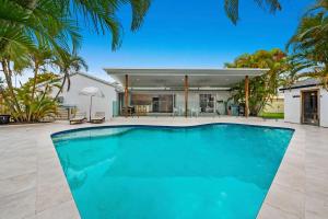 a swimming pool in front of a house at Luxury home in the heart of Burleigh in Gold Coast