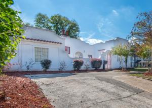 a white house with a driveway at A Spanish Castle For Your Living Pleasure in Little Rock