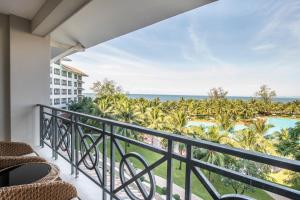 a balcony with a view of the ocean and a resort at Vinpearl Resort & Spa Phu Quoc in Phu Quoc