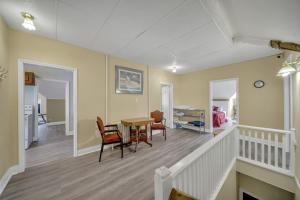 a living room with a dining room table and chairs at Marmora and Lake Inn and Victorian Diner in Marmora