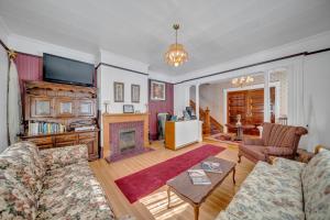 a living room with a couch and a fireplace at Marmora and Lake Inn and Victorian Diner in Marmora