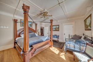 a bedroom with a bed and a ceiling fan at Marmora and Lake Inn and Victorian Diner in Marmora