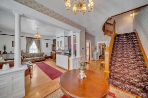 a living room with a staircase and a table at Marmora and Lake Inn in Marmora