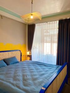 a bedroom with a blue bed and a window at Homestay Casa 69 in Hanoi