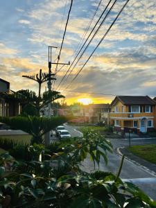 a view of a street with a sunset in the background at Stanford Resedence in Silang
