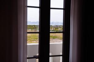 uma vista de uma janela com vista para um campo em Navy Hotel Ha Long em Ha Long