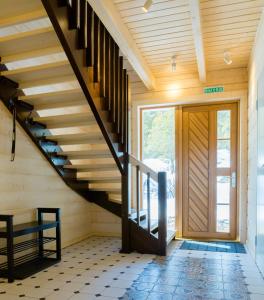 a staircase in a house with a wooden ceiling at Park Hotel Kokshetau in Shchūchīnsk
