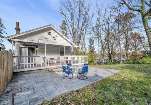 a house with a patio with a bench in the yard at Cozy Cottage in the Heart of Hyde Park home in Cincinnati
