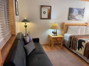 a living room with a couch and a bed at Red River Condo #4 in Red River