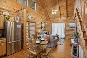 a kitchen and living room in a log cabin at 5 O'Clock Somewhere cabin in Sevierville