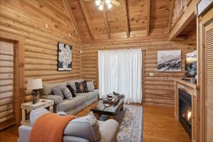 a living room with a couch and a fireplace at 5 O'Clock Somewhere cabin in Sevierville