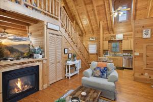 a living room with a fireplace in a log cabin at 5 O'Clock Somewhere cabin in Sevierville +15 photos