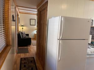 a white refrigerator in a kitchen with a living room at Red River Condo #4 in Red River