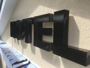 a black sign on a wall with a keyboard at Hotel Haus Loewe in Frechen