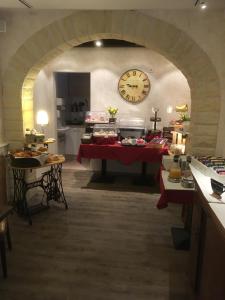 a room with a table with a clock on the wall at Hotel Haus Loewe in Frechen