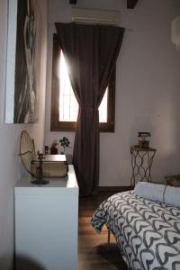 a bedroom with a bed and a window at BETÌ in Taranto