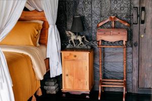 a bedroom with a bed and a lamp on a dresser at Most Exotic Villa Keong in Tabanan