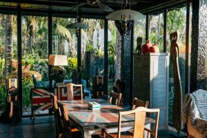 a dining room with a wooden table and chairs at Most Exotic Villa Keong in Tabanan