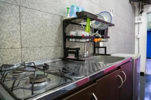 a kitchen with a stove and a sink at Hotel Family House Rodadero in Santa Marta