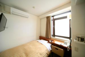 Кровать или кровати в номере Nagano Daiichi Hotel